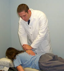 dr henry performs chiropractic adjustment